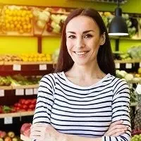 Businesswoman presenting eco fruit in retail space